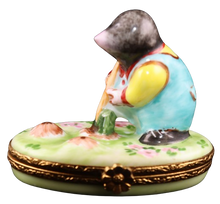 Load image into Gallery viewer, A hand-painted, numbered and signed Limoges box featuring an artistic depiction of a mole with a shovel in a garden setting.