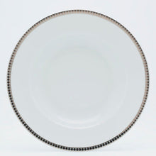 Load image into Gallery viewer, Round white plate with decorative rim on a light gray background
